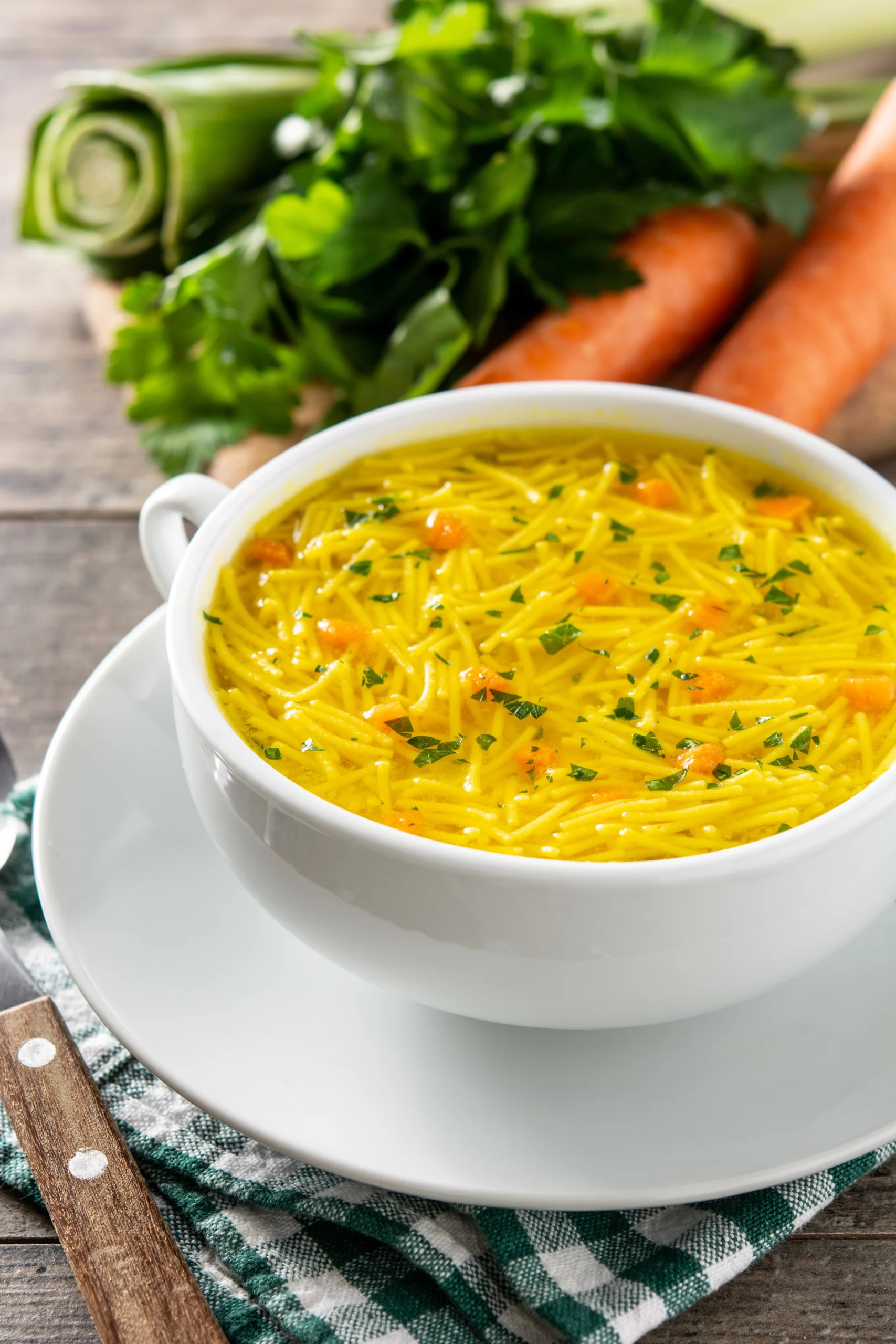 chicken-noodle-soup-white-bowl-wooden-table